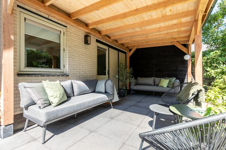 De ruime houten veranda van vakantiehuis Hendrika op de Veluwe